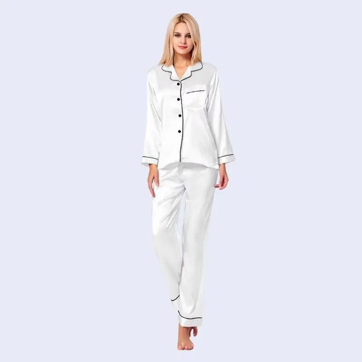 Mannequin portant un ensemble pyjama chemisier long boutonné et pantalon en satin brillant couleur blanche