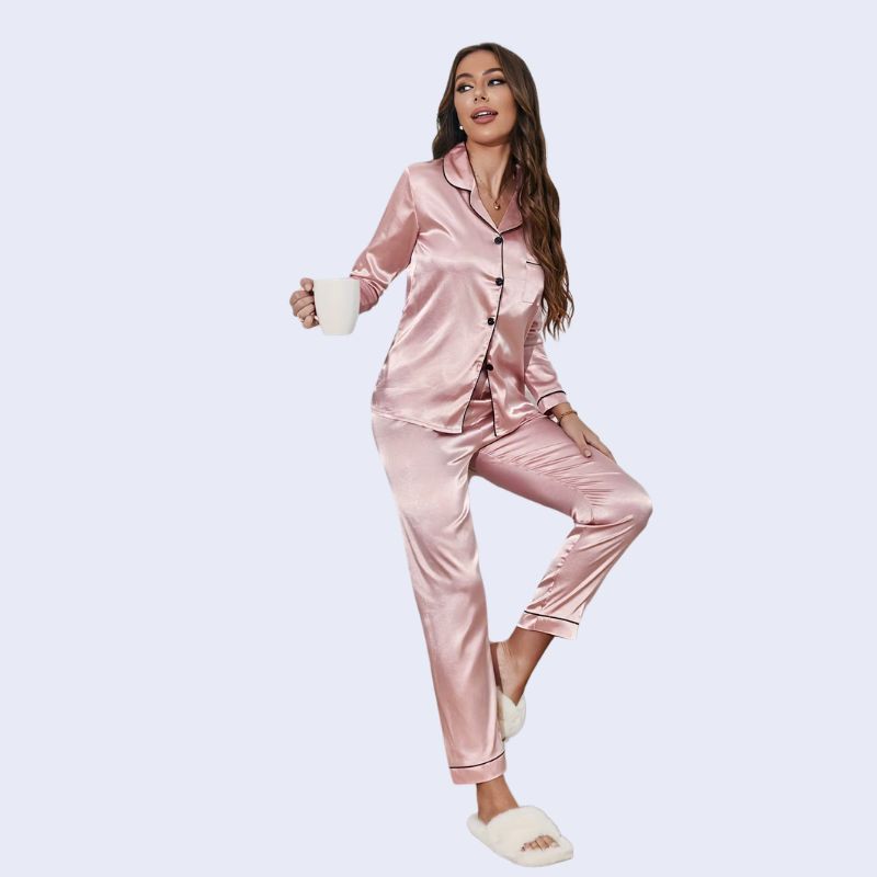 Mannequin portant un ensemble pyjama chemisier long boutonné et pantalon en satin brillant couleur rose