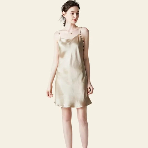 Modèle de face portant une mini-robe brillante à bretelles fines 100% soie couleur champagne
