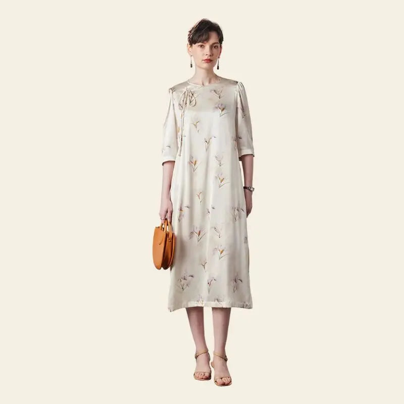 Mannequin de face portant une robe élégante mi-longue florale pure soie couleur champagne