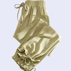 Sarouel plissé poches et nœuds en satin jaune olive